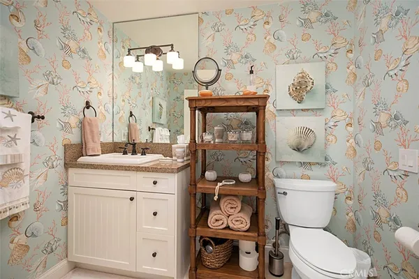 a white toilet sitting next to a bathroom sink