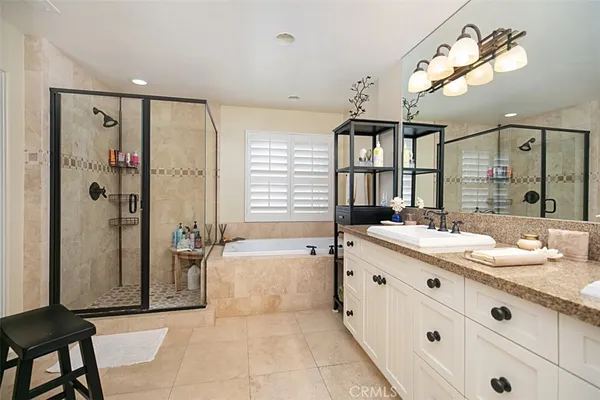 a large bathroom with a sink mirror and shower