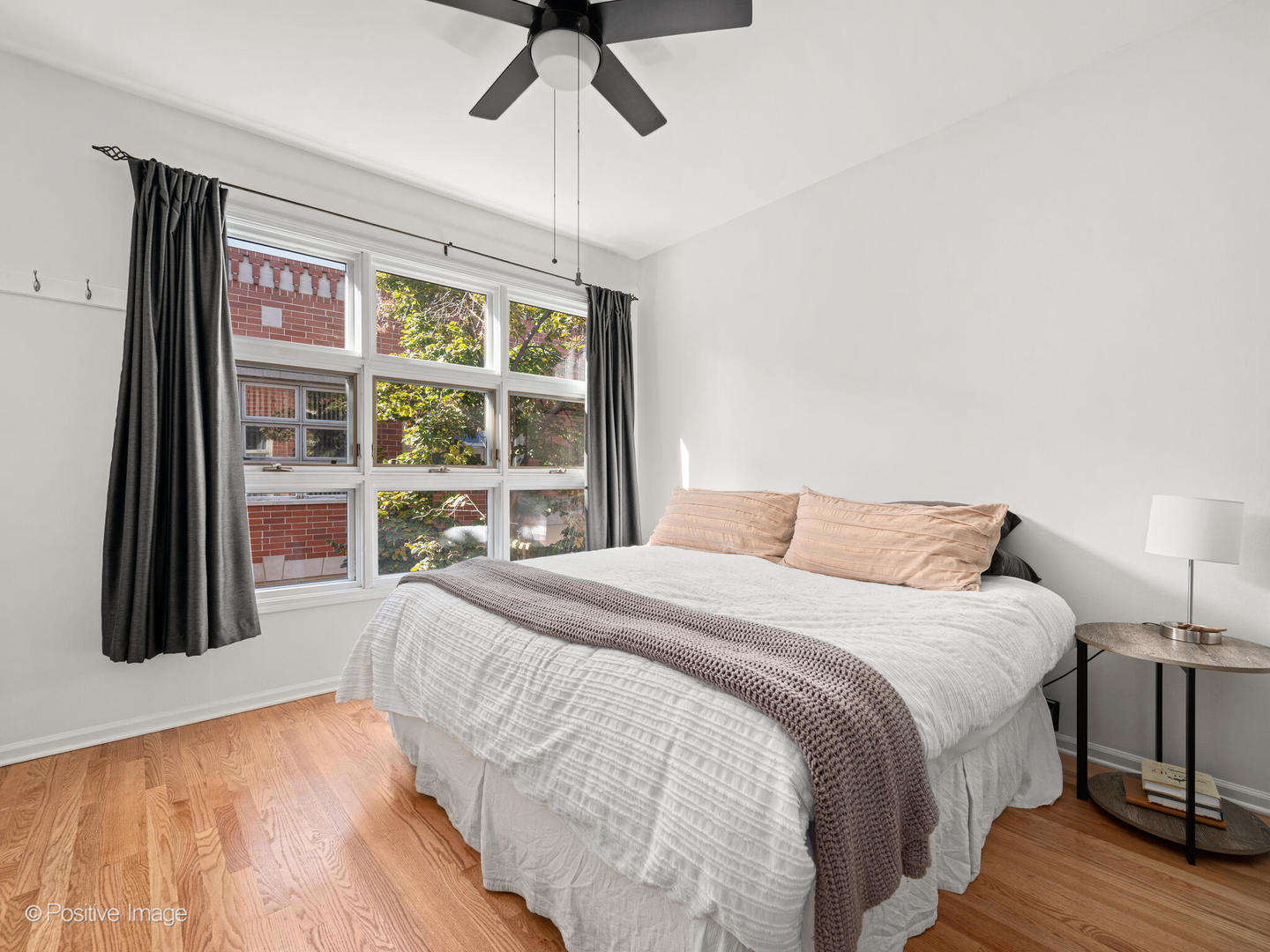 855 West Erie Street, Unit 107 Chicago, IL 60642 - Photo 7 of 21 a bedroom with a bed and a large window
