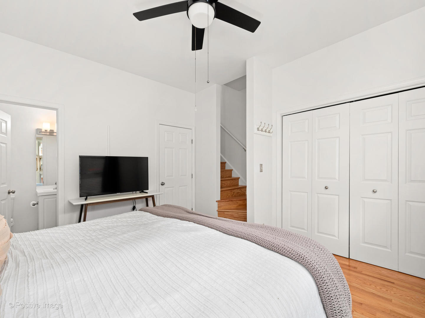 855 West Erie Street, Unit 107 Chicago, IL 60642 - Photo 8 of 21 a bedroom with a bed and a flat tv screen on a dresser
