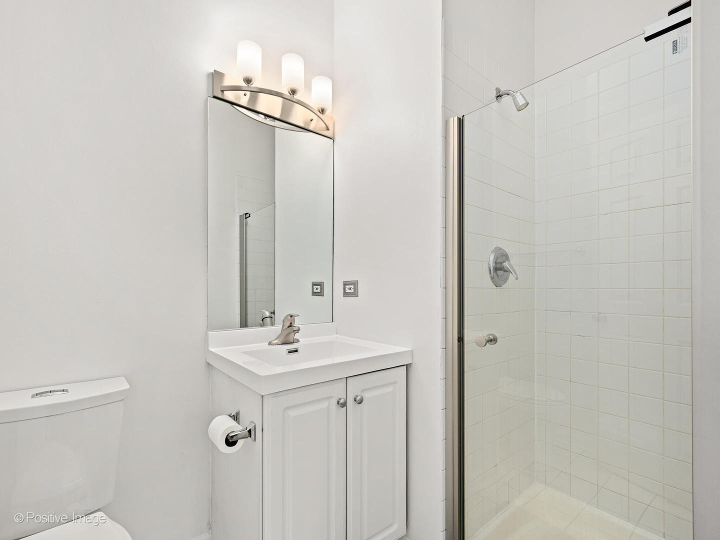 855 West Erie Street, Unit 107 Chicago, IL 60642 - Photo 9 of 21 a bathroom with a sink mirror and toilet