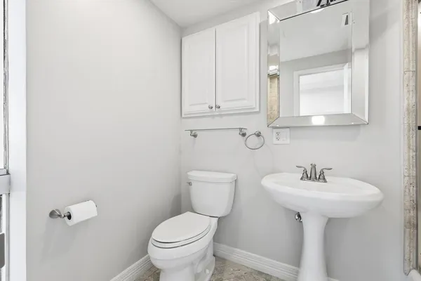 a bathroom with a sink mirror toilet and bathtub