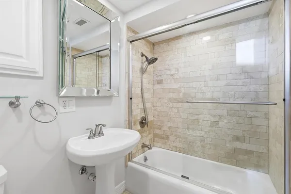 an empty room with wooden floor and natural light