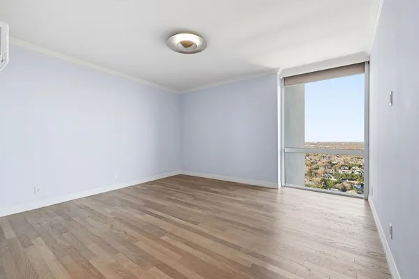 a view of an empty room and wooden floor