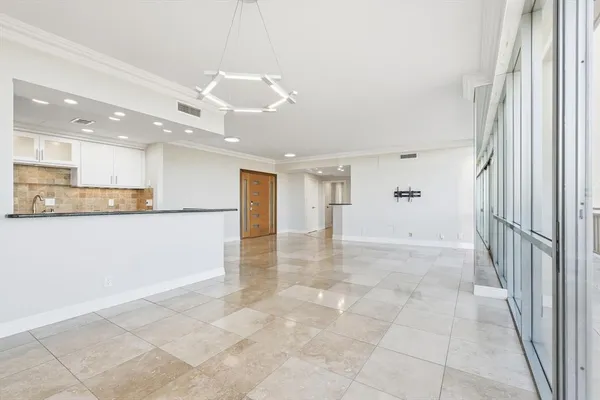 a view of a kitchen with a refrigerator and cabinets