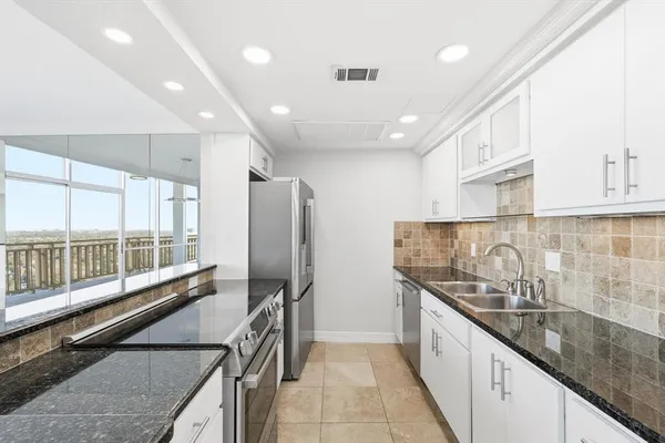 a kitchen with a sink and cabinets