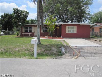 2120 Earl Road Fort Myers, FL 33901 - Photo 4 of 10 a front view of a house with a yard and garage