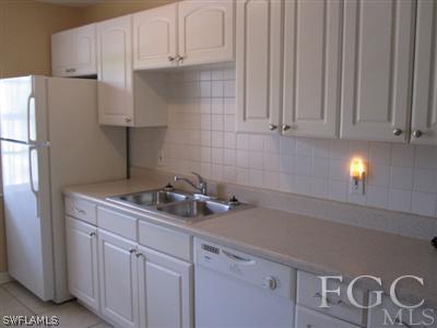 2120 Earl Road Fort Myers, FL 33901 - Photo 8 of 10 a kitchen with appliances cabinets and a counter top space