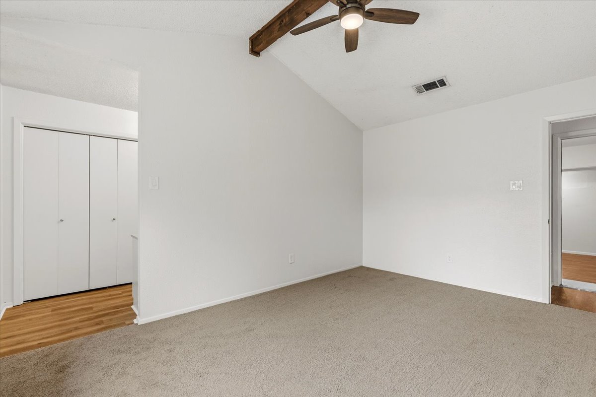 511 Suzzane Road Pflugerville, TX 78660 - Photo 14 of 35 Unfurnished bedroom featuring light colored new carpet, beamed ceiling, and a ceiling fan