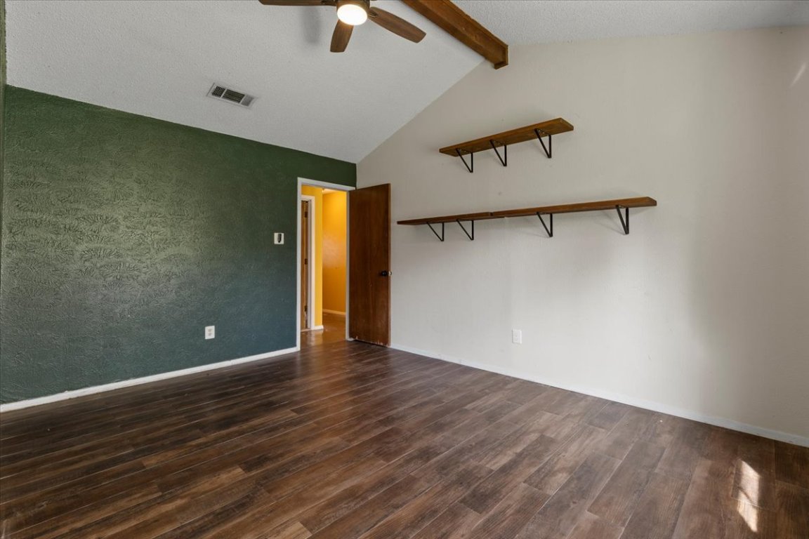 511 Suzzane Road Pflugerville, TX 78660 - Photo 14 of 34 Primary room featuring dark wood-type flooring and a ceiling fan
