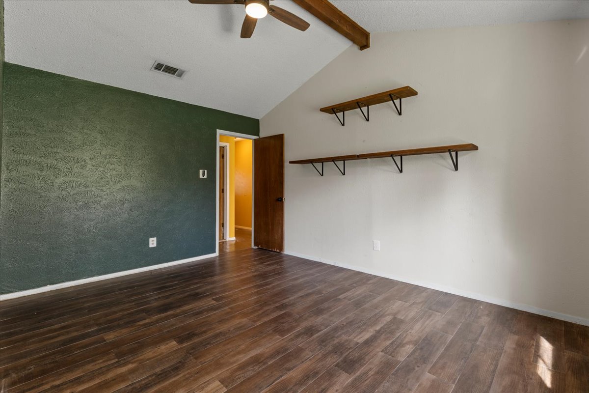 511 Suzzane Road Pflugerville, TX 78660 - Photo 16 of 37 Primary room featuring dark wood-type flooring and a ceiling fan