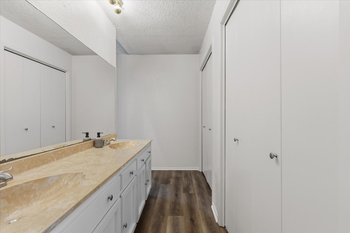 511 Suzzane Road Pflugerville, TX 78660 - Photo 16 of 35 a bathroom with a granite countertop sink a vanity and shower