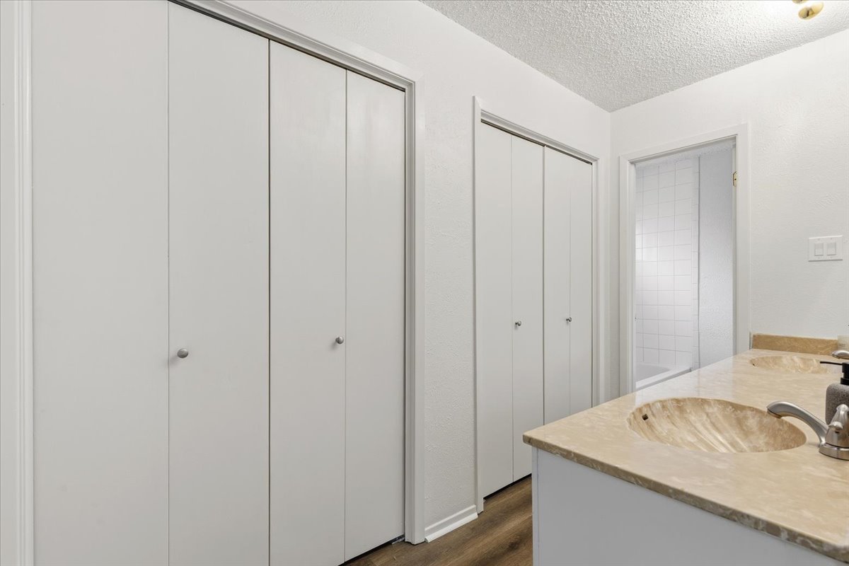 511 Suzzane Road Pflugerville, TX 78660 - Photo 17 of 35 Full bath with double vanity, new LVP floors, and a textured ceiling