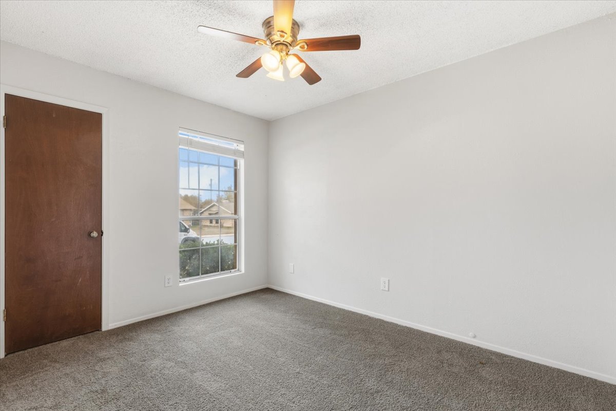511 Suzzane Road Pflugerville, TX 78660 - Photo 18 of 35 an empty room with windows and fan