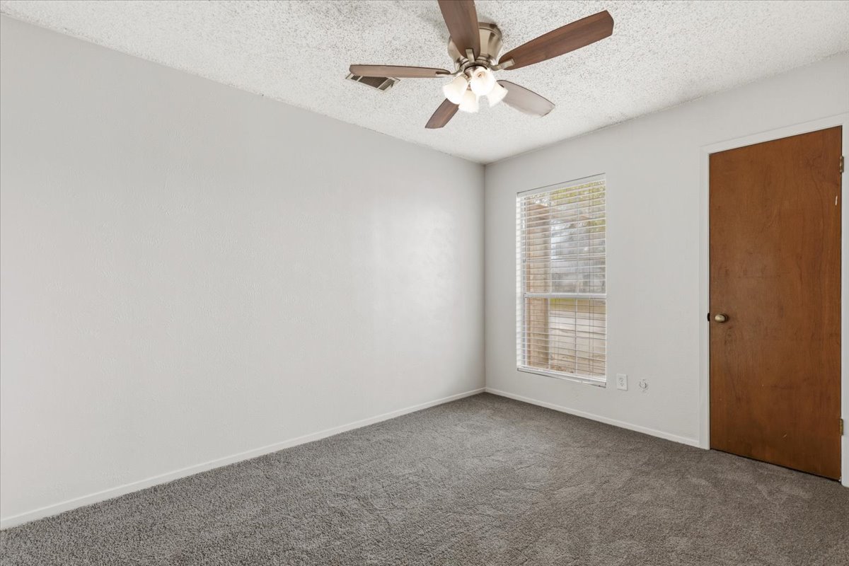 511 Suzzane Road Pflugerville, TX 78660 - Photo 20 of 35 an empty room with windows and fan