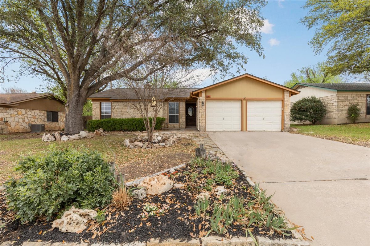 511 Suzzane Road Pflugerville, TX 78660 - Photo 2 of 35 a front view of a house with a yard and garage