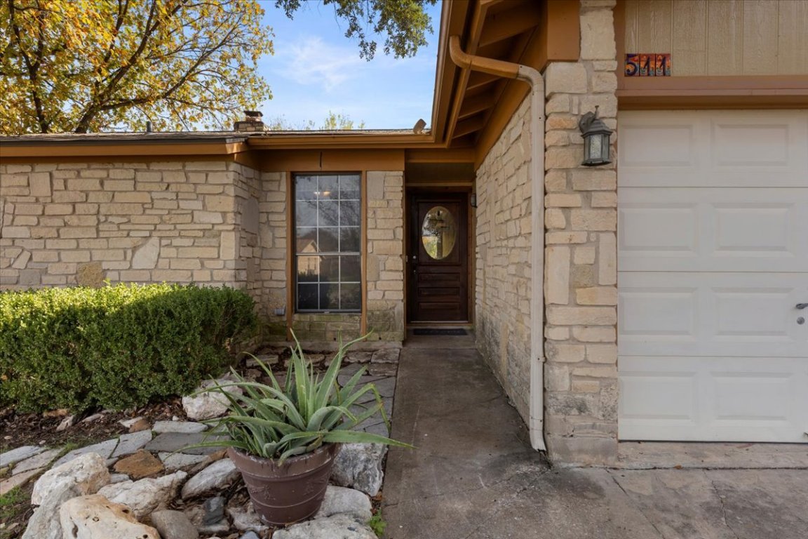 511 Suzzane Road Pflugerville, TX 78660 - Photo 5 of 34 Doorway to property featuring stone siding