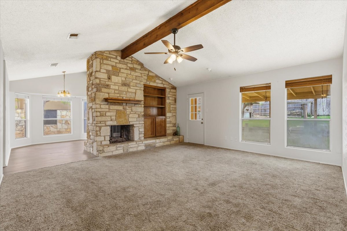 511 Suzzane Road Pflugerville, TX 78660 - Photo 6 of 35 an empty room with windows and fireplace