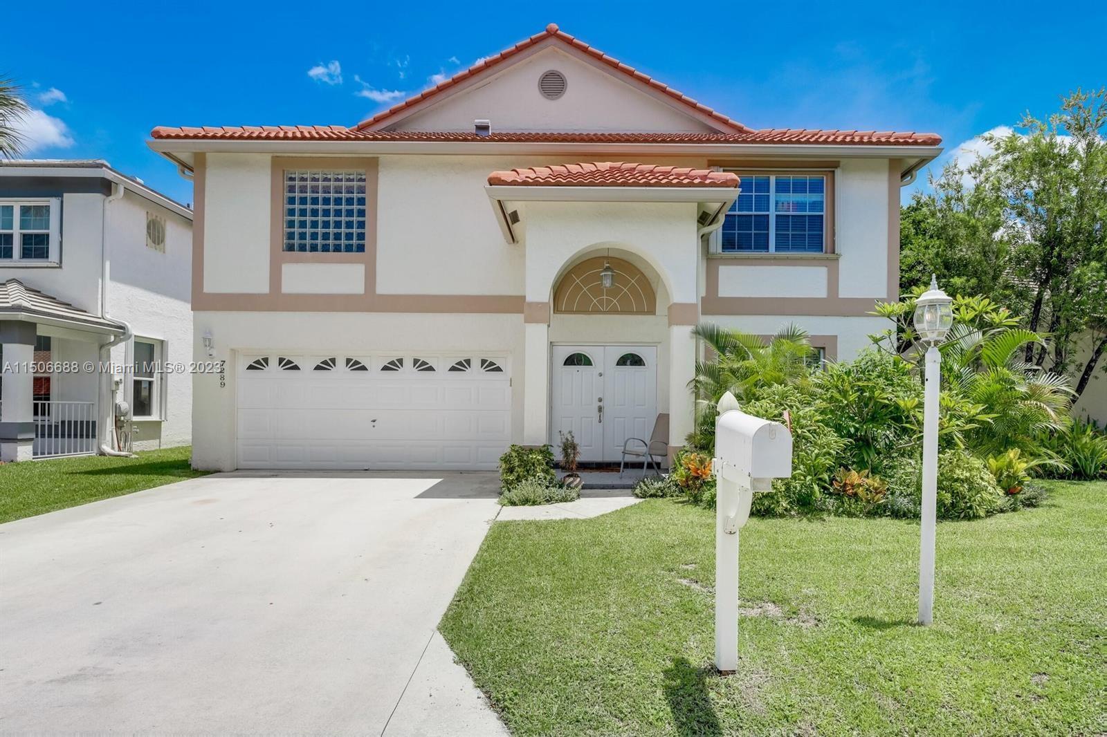 7289 Shell Ridge Terrace Lake Worth, FL 33467 - Photo 1 of 55 a front view of a house with a yard