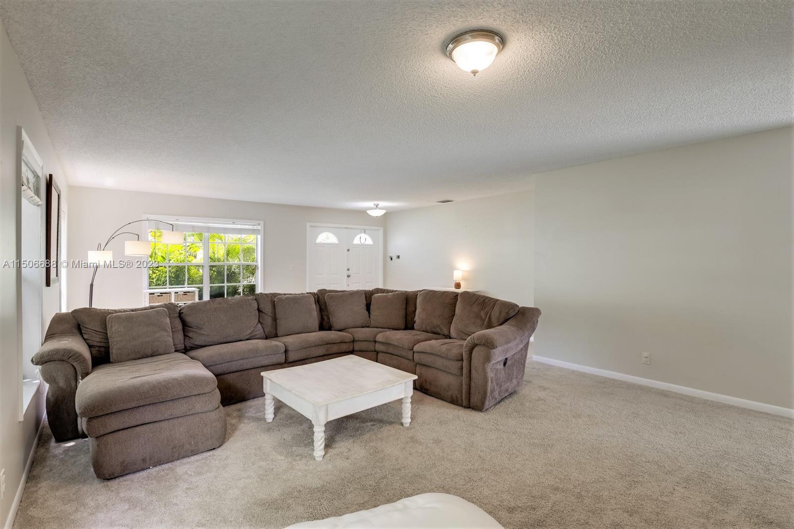 7289 Shell Ridge Terrace Lake Worth, FL 33467 - Photo 11 of 55 a living room with furniture and a large window