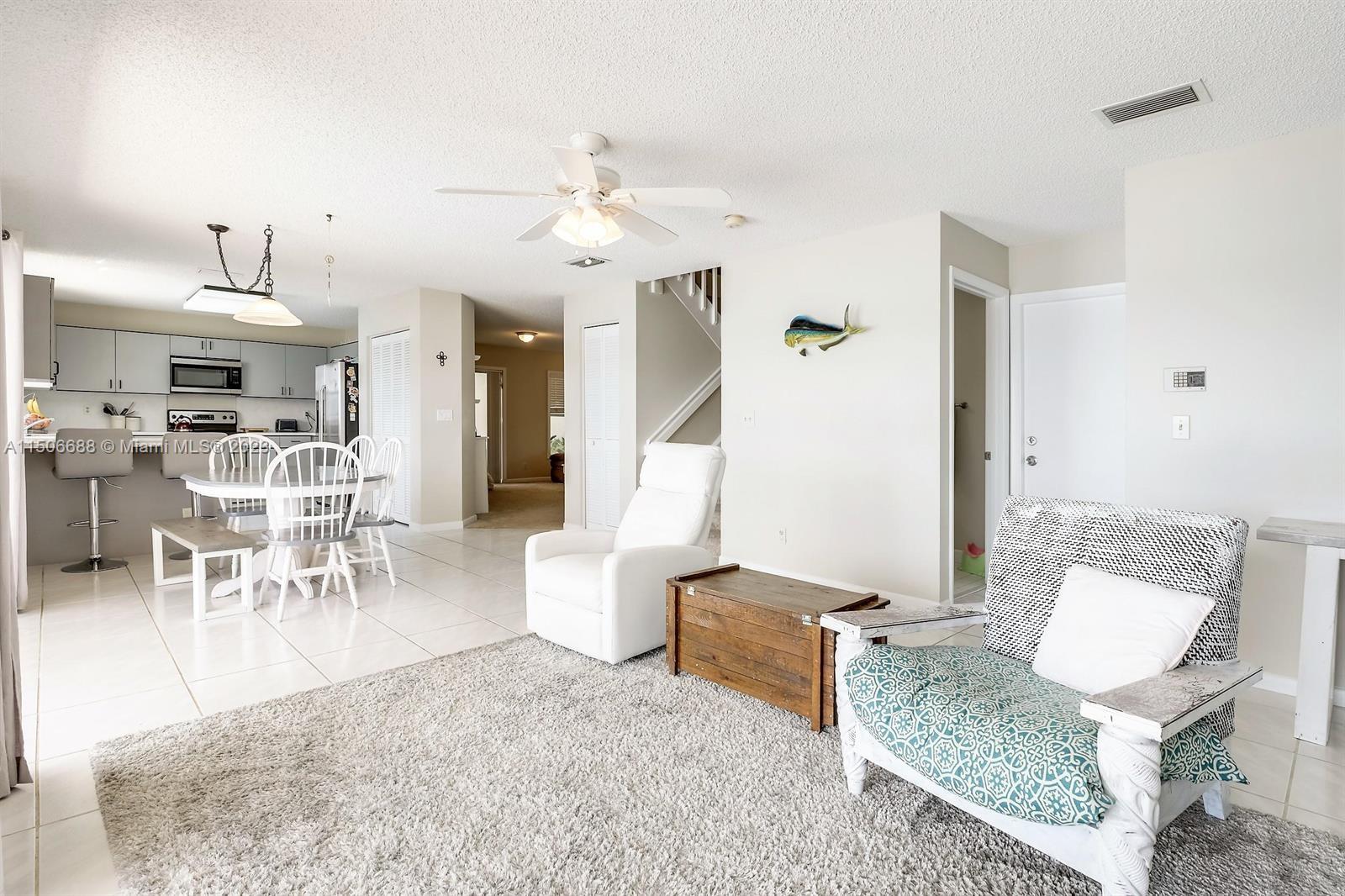 7289 Shell Ridge Terrace Lake Worth, FL 33467 - Photo 13 of 55 a living room with furniture and a chandelier
