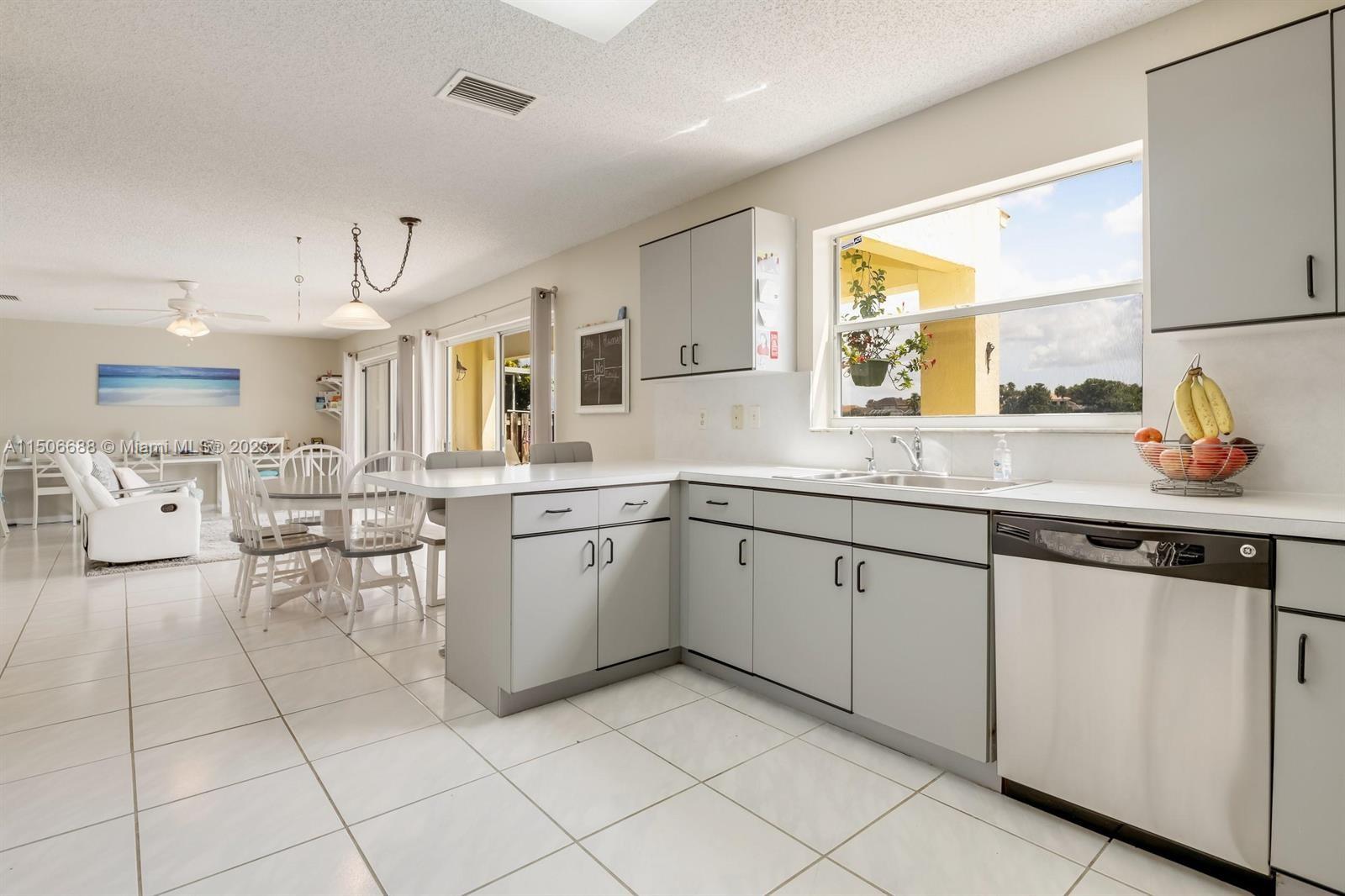 7289 Shell Ridge Terrace Lake Worth, FL 33467 - Photo 16 of 55 a kitchen with sink cabinets and window