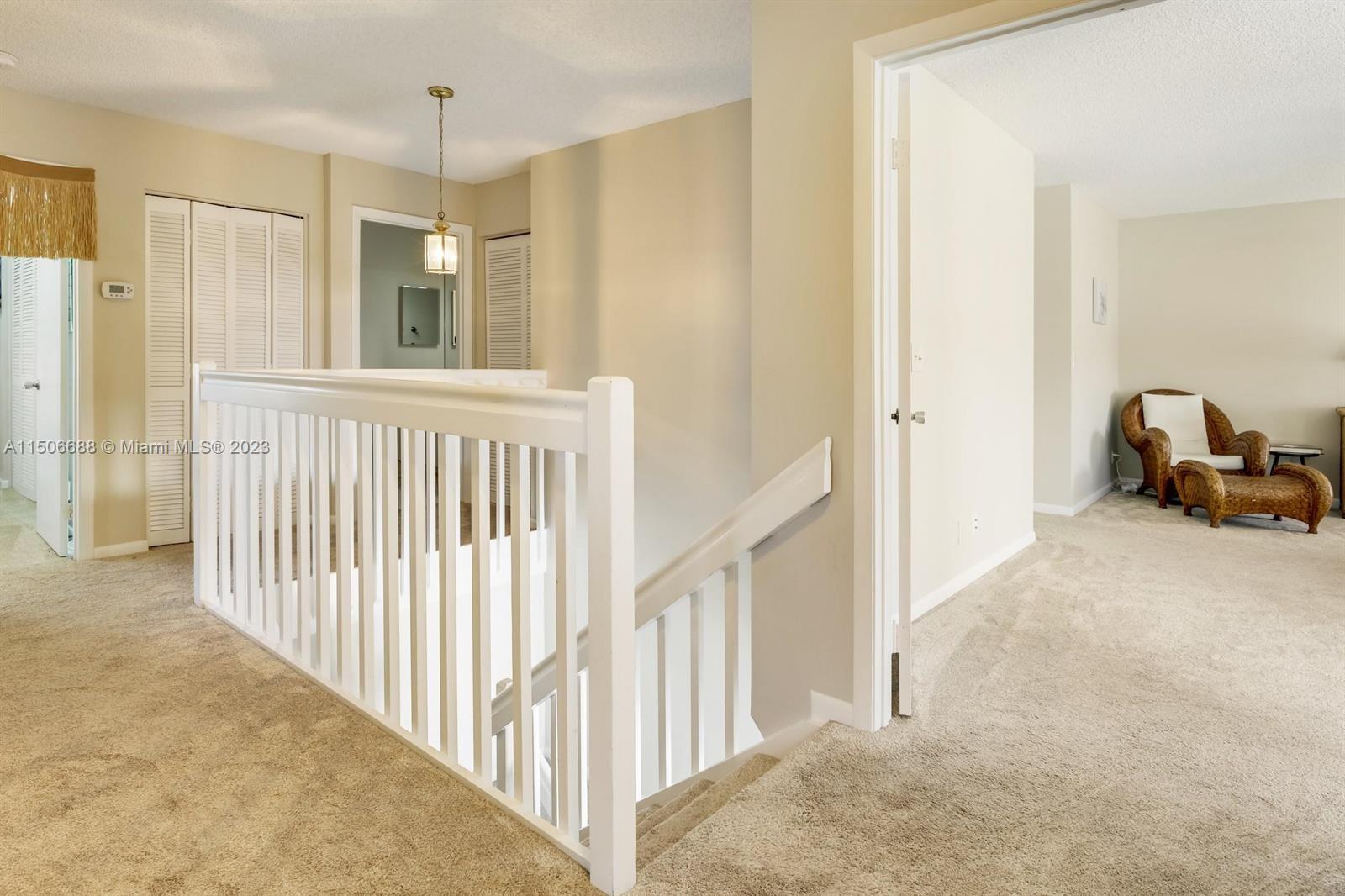 7289 Shell Ridge Terrace Lake Worth, FL 33467 - Photo 21 of 55 a view of a hallway to a livingroom with wooden floor and staircase