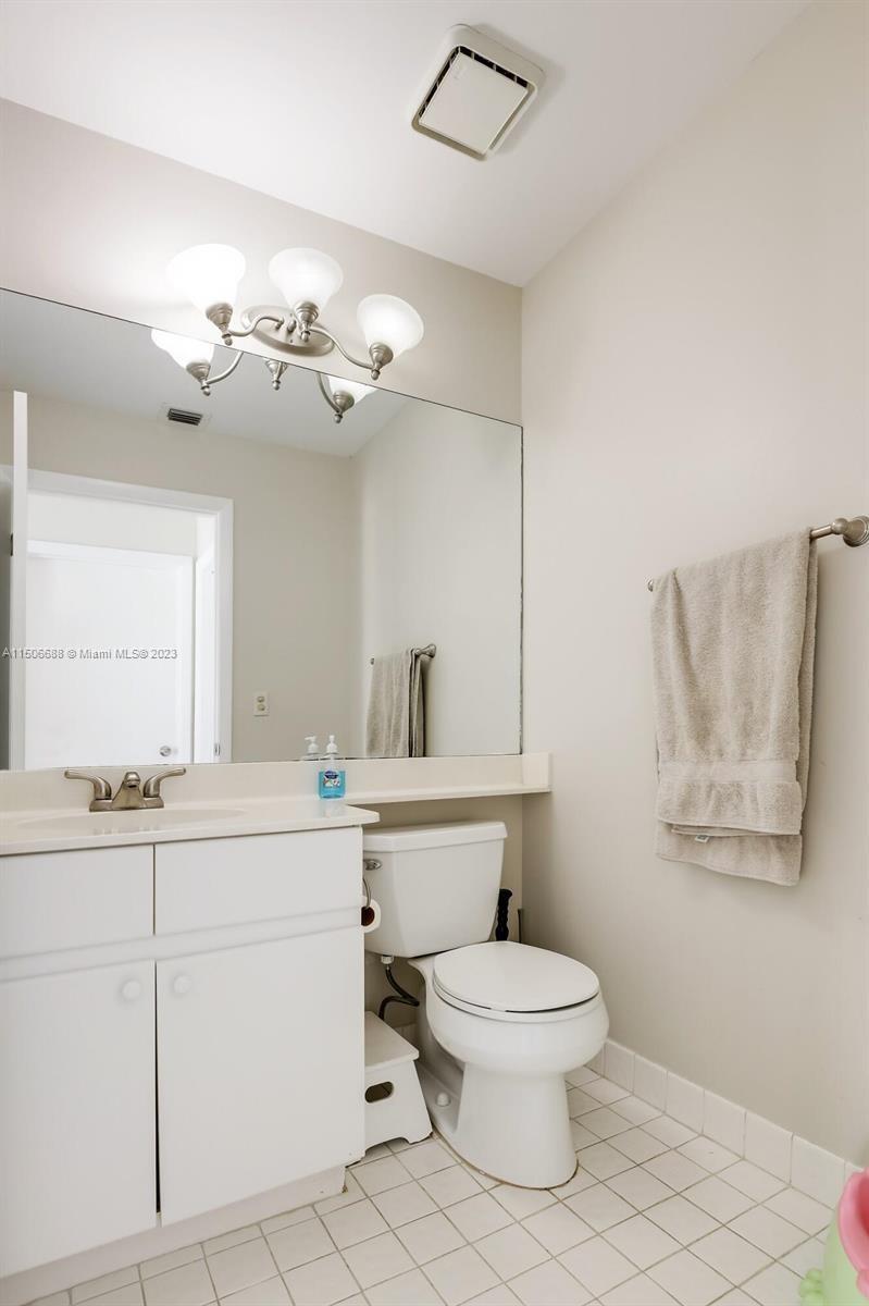 7289 Shell Ridge Terrace Lake Worth, FL 33467 - Photo 23 of 55 a bathroom with a toilet sink and mirror