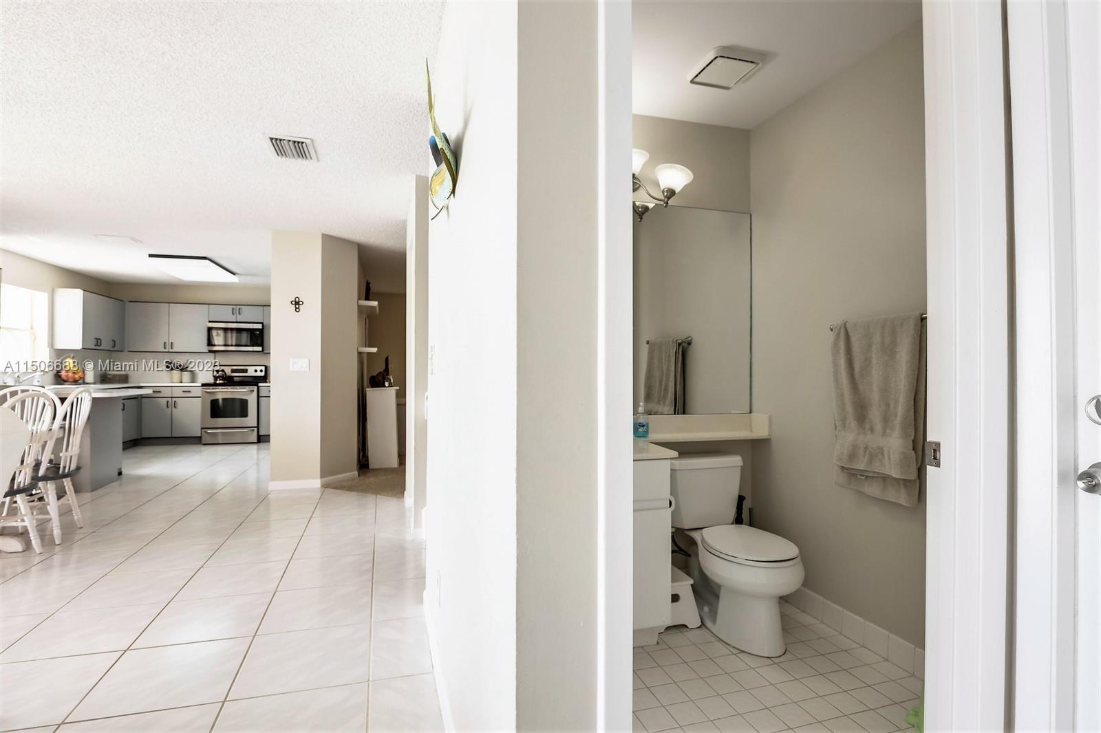7289 Shell Ridge Terrace Lake Worth, FL 33467 - Photo 24 of 55 a bathroom with a toilet sink and a mirror