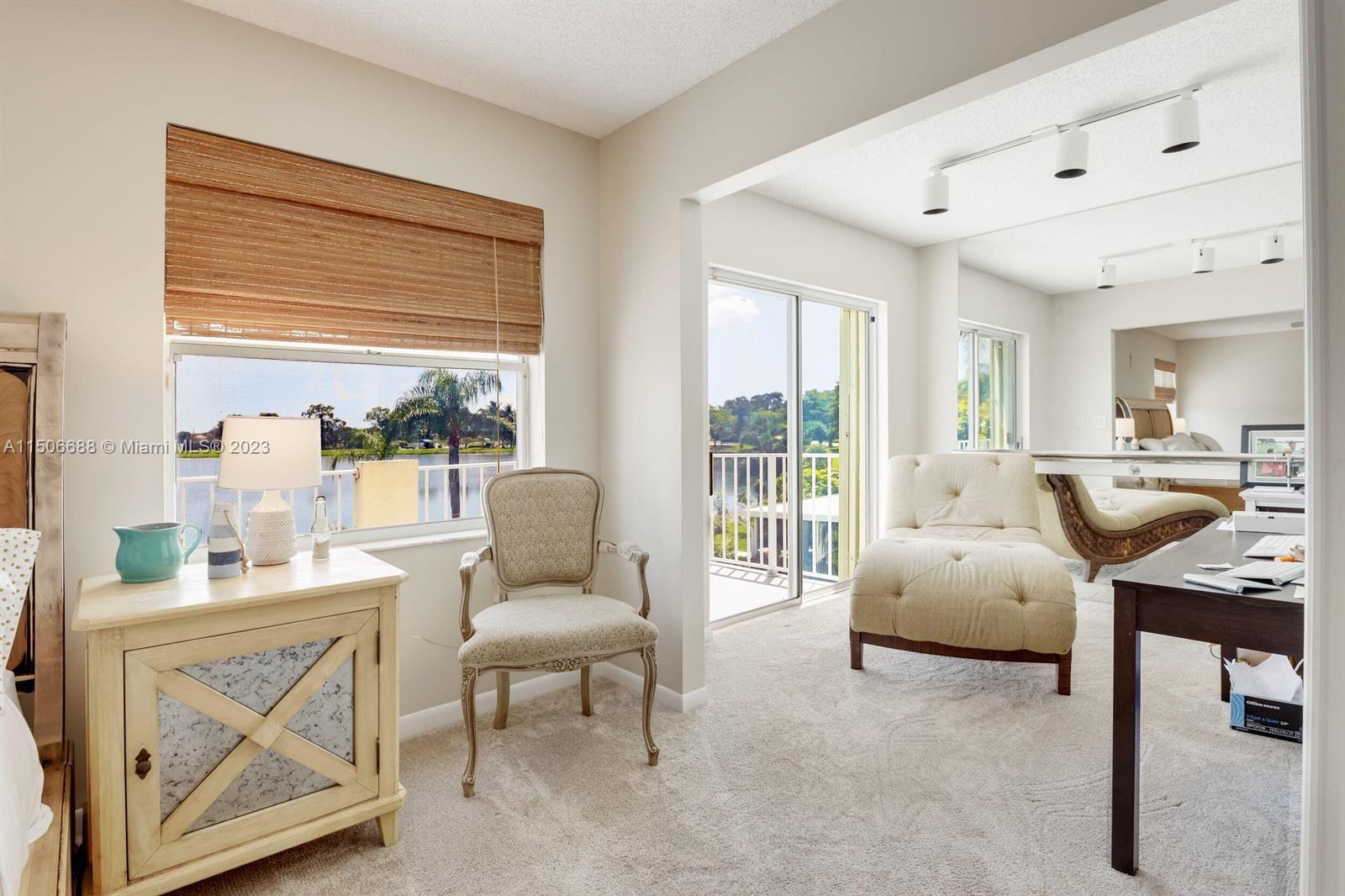 7289 Shell Ridge Terrace Lake Worth, FL 33467 - Photo 27 of 55 a living room with furniture and a large window
