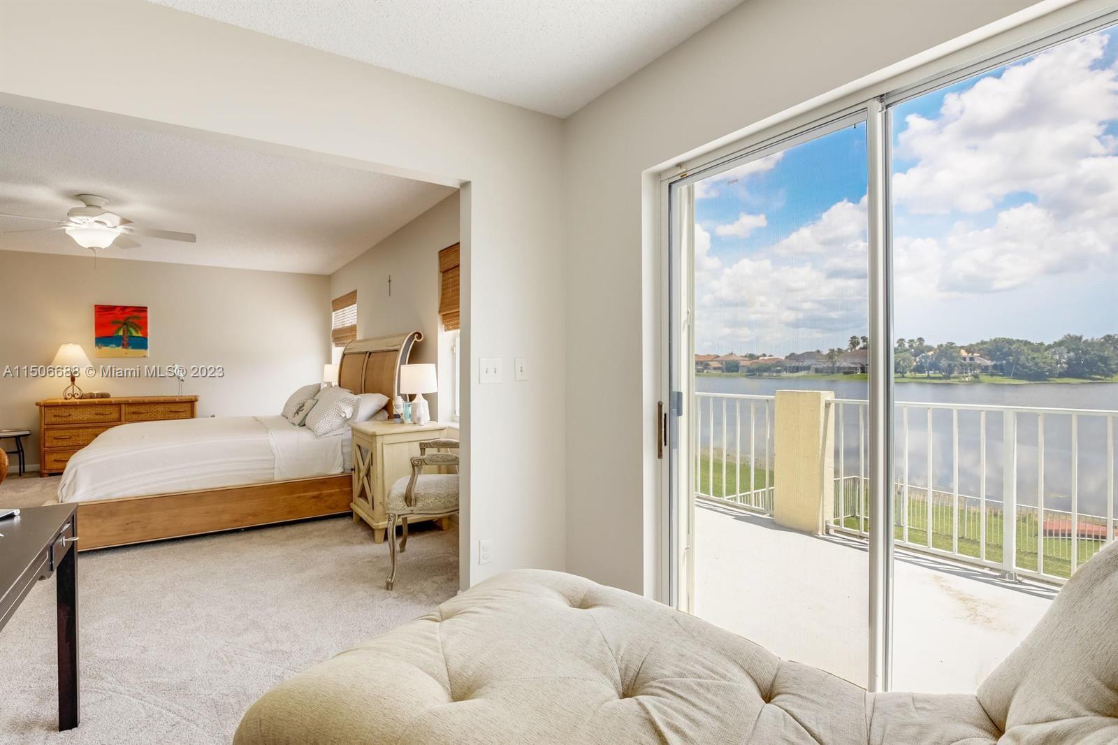 7289 Shell Ridge Terrace Lake Worth, FL 33467 - Photo 29 of 55 a bedroom with a large bed and a large window