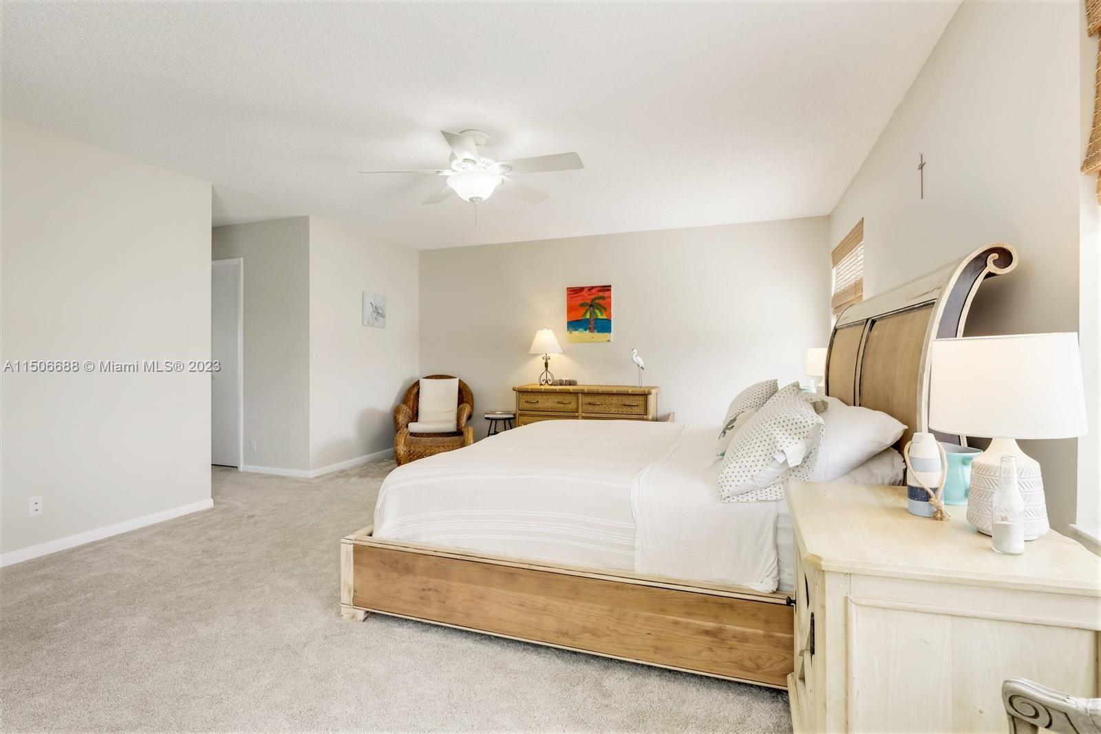 7289 Shell Ridge Terrace Lake Worth, FL 33467 - Photo 30 of 55 a bedroom with a bed and a lamp
