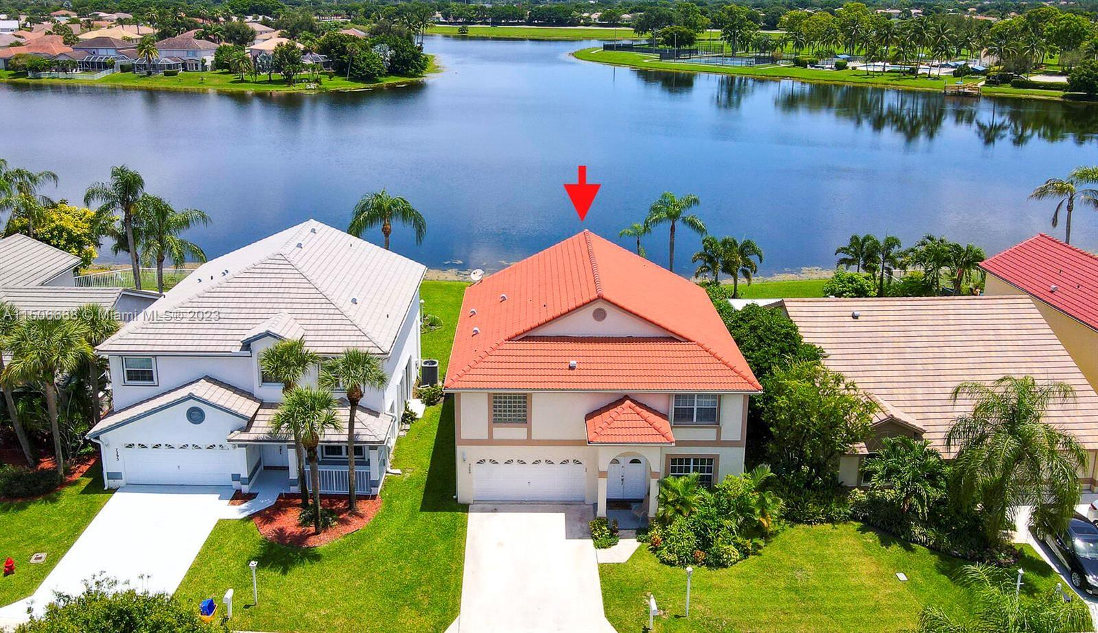 7289 Shell Ridge Terrace Lake Worth, FL 33467 - Photo 3 of 55 an aerial view of a house with a lake view