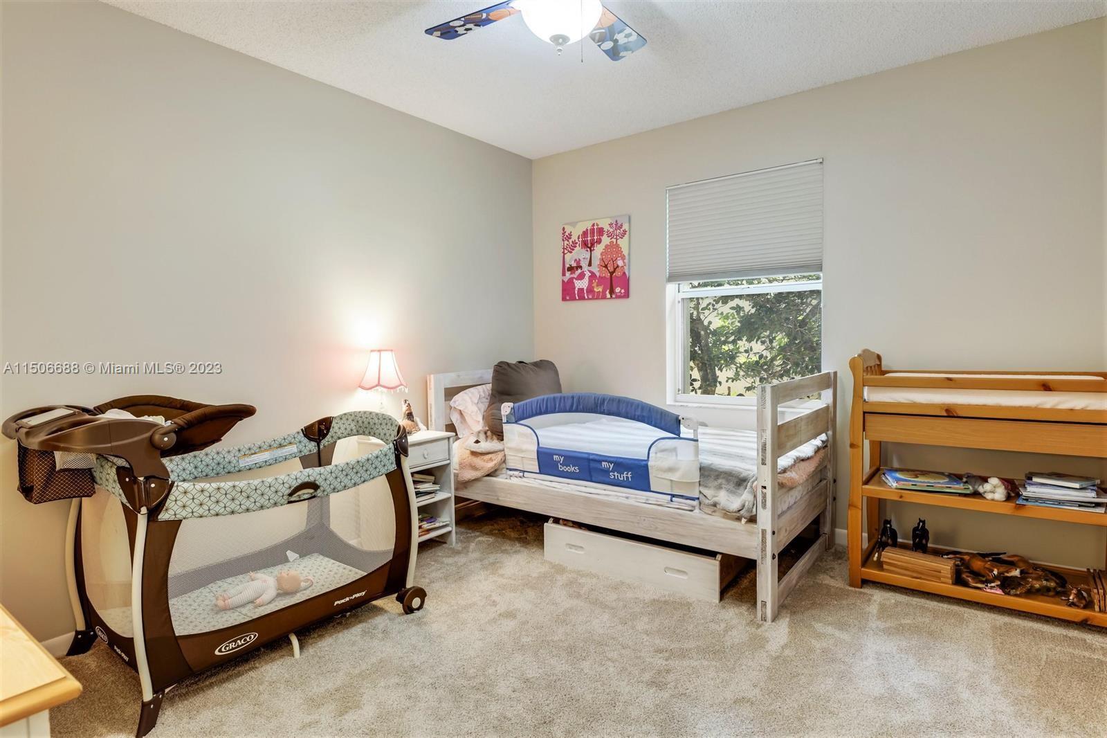7289 Shell Ridge Terrace Lake Worth, FL 33467 - Photo 35 of 55 a bedroom with furniture and a fan