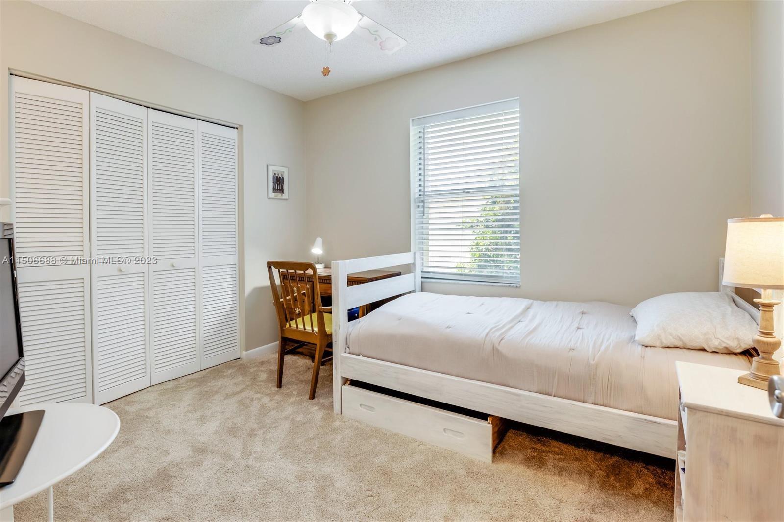 7289 Shell Ridge Terrace Lake Worth, FL 33467 - Photo 37 of 55 a bedroom with a bed and a chandelier