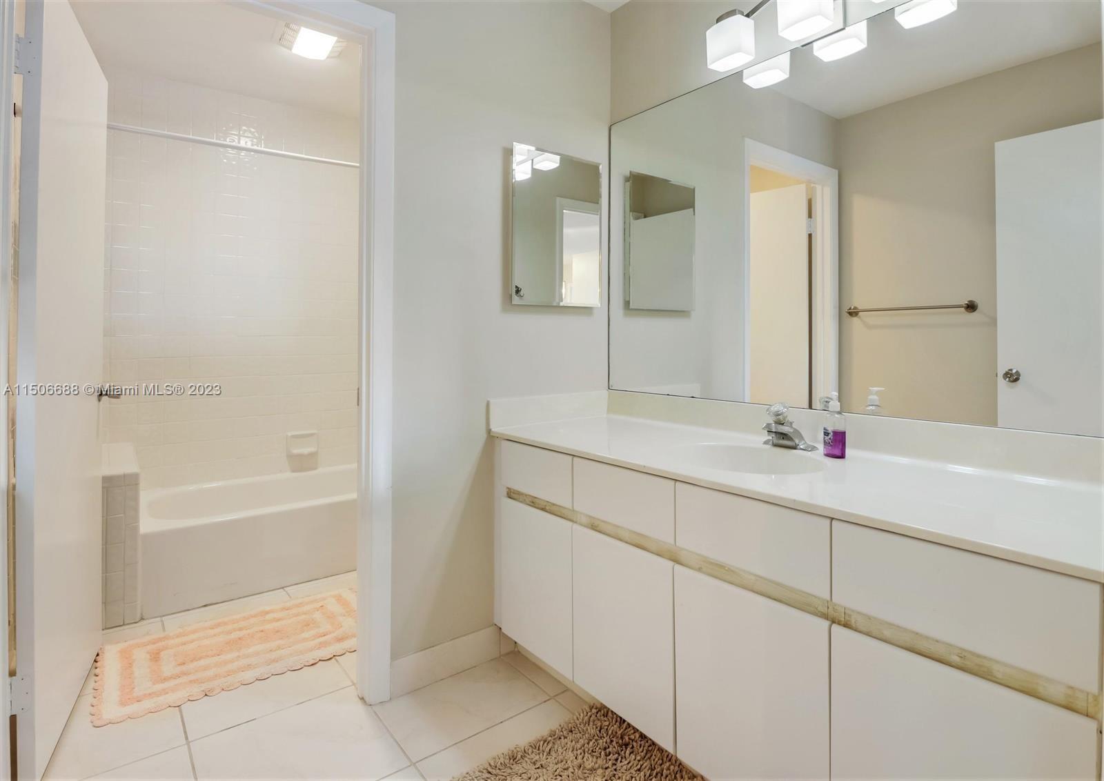 7289 Shell Ridge Terrace Lake Worth, FL 33467 - Photo 40 of 55 a bathroom with a tub sink and mirror