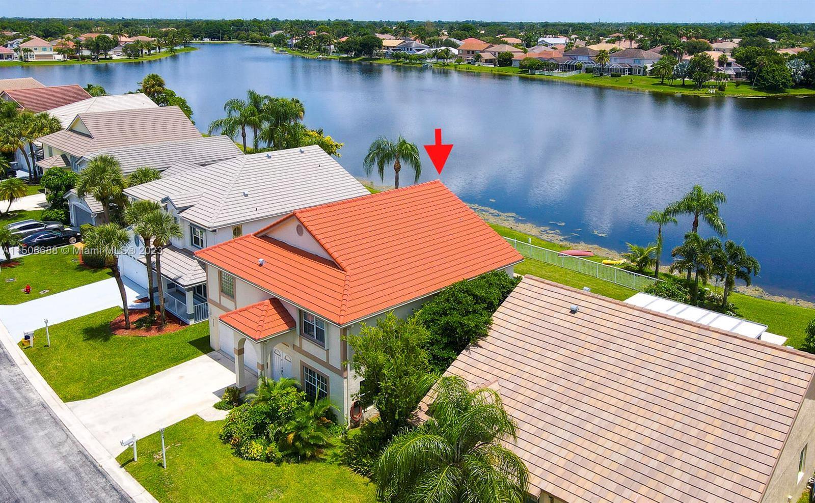 7289 Shell Ridge Terrace Lake Worth, FL 33467 - Photo 4 of 55 an aerial view of a house with a lake view
