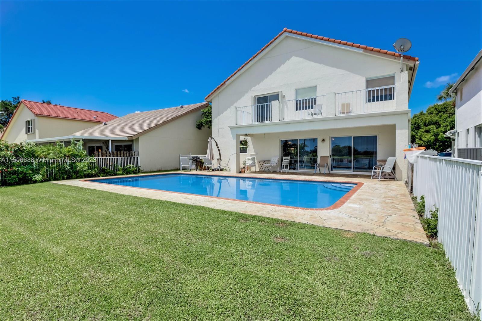 7289 Shell Ridge Terrace Lake Worth, FL 33467 - Photo 41 of 55 a view of house with swimming pool and yard