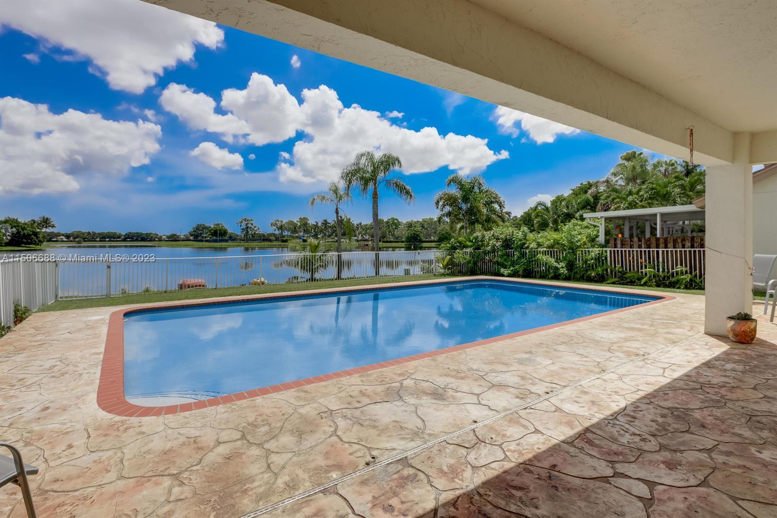 7289 Shell Ridge Terrace Lake Worth, FL 33467 - Photo 44 of 55 a view of swimming pool with outdoor seating and plants