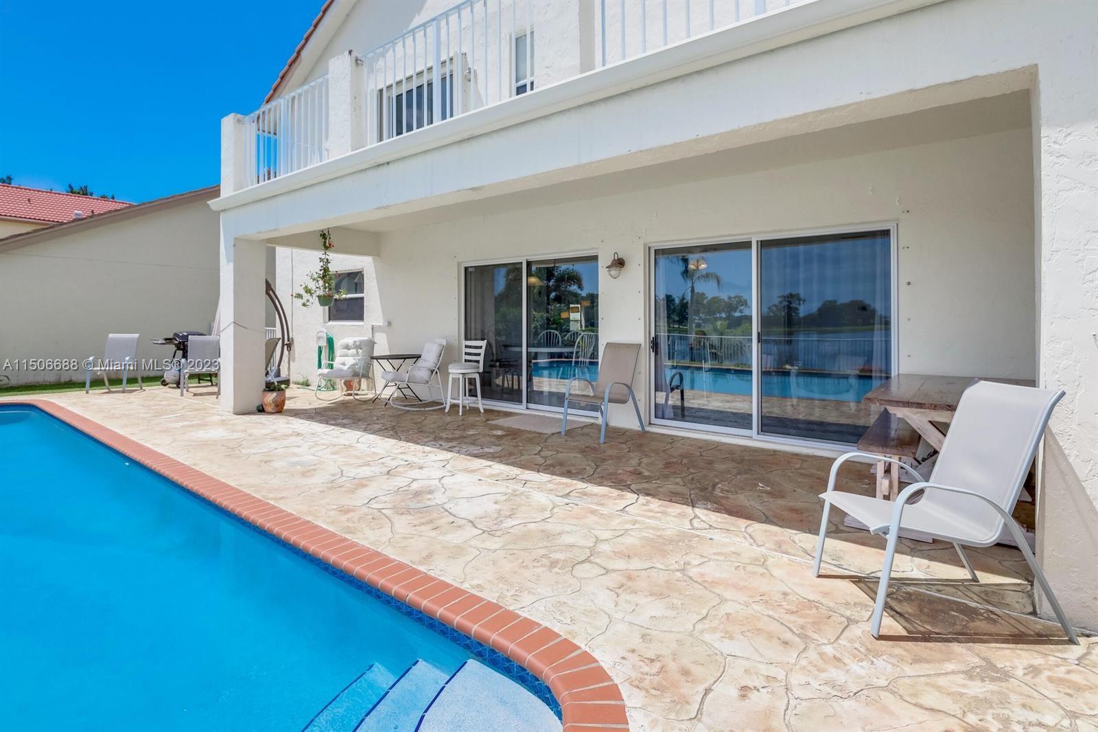 7289 Shell Ridge Terrace Lake Worth, FL 33467 - Photo 48 of 55 a swimming pool with outdoor seating and yard