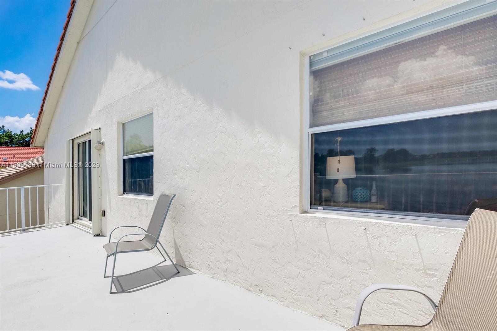 7289 Shell Ridge Terrace Lake Worth, FL 33467 - Photo 49 of 55 a view of a fireplace with chairs and a table in room