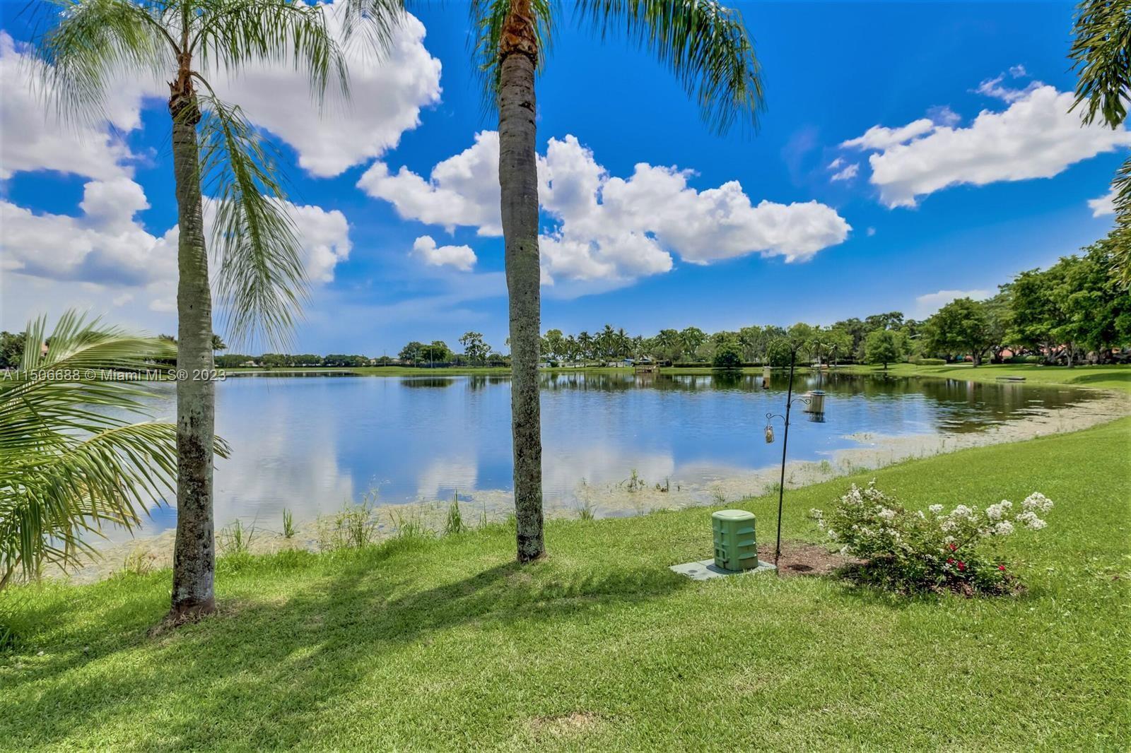 7289 Shell Ridge Terrace Lake Worth, FL 33467 - Photo 52 of 55 a backyard of a house with lots of green space and lake view