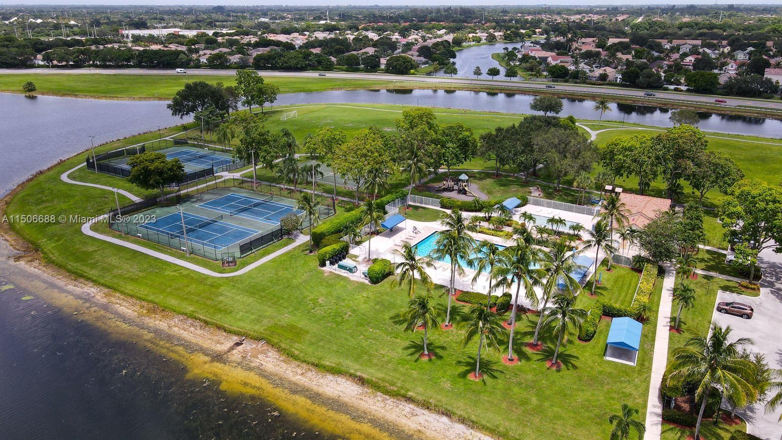 7289 Shell Ridge Terrace Lake Worth, FL 33467 - Photo 54 of 55 an aerial view of a house with a garden and lake view
