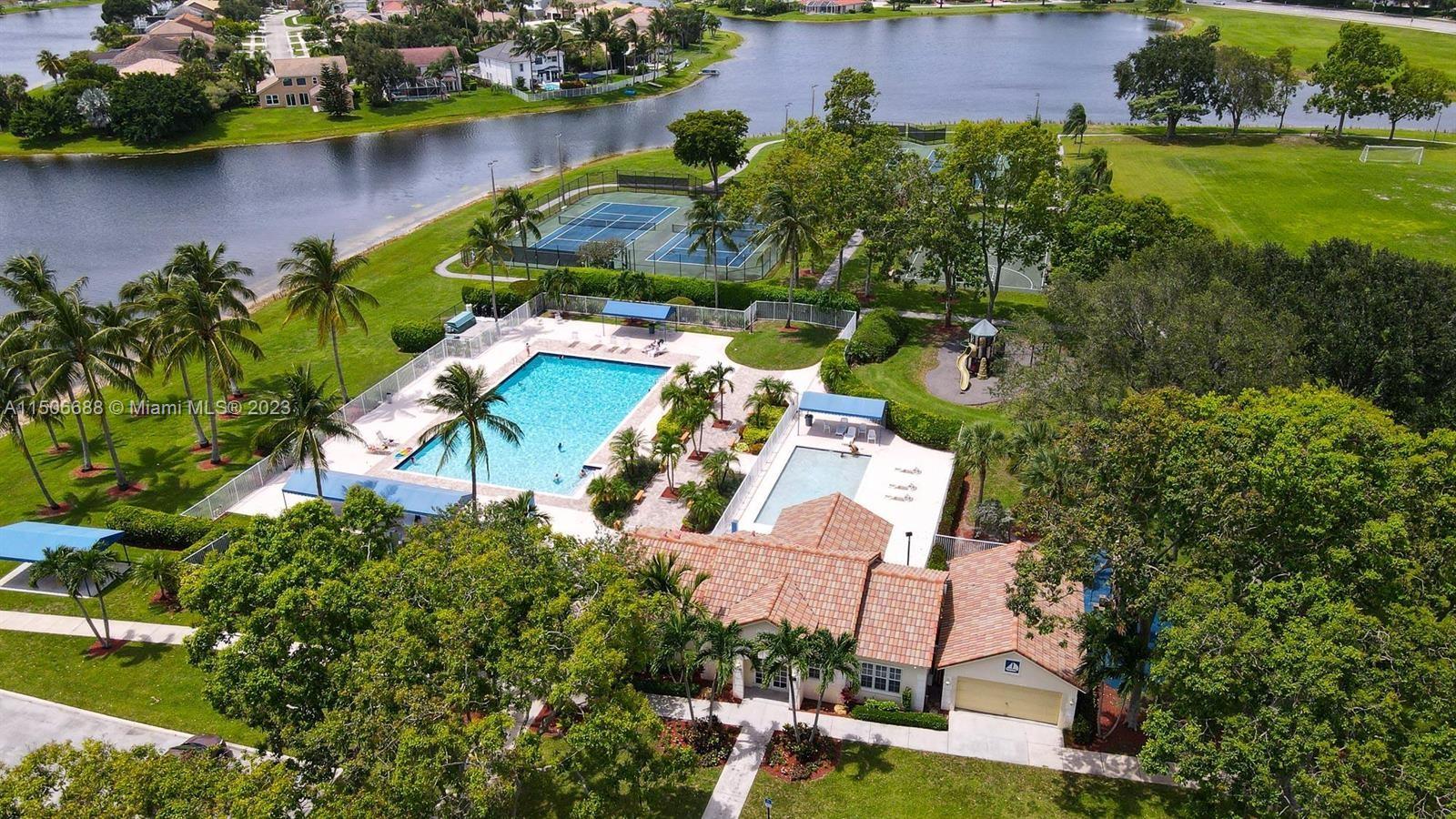 7289 Shell Ridge Terrace Lake Worth, FL 33467 - Photo 55 of 55 an aerial view of residential houses with outdoor space and lake view