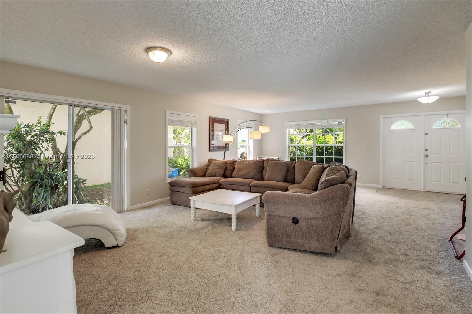 7289 Shell Ridge Terrace Lake Worth, FL 33467 - Photo 10 of 55 a living room with furniture and a large window