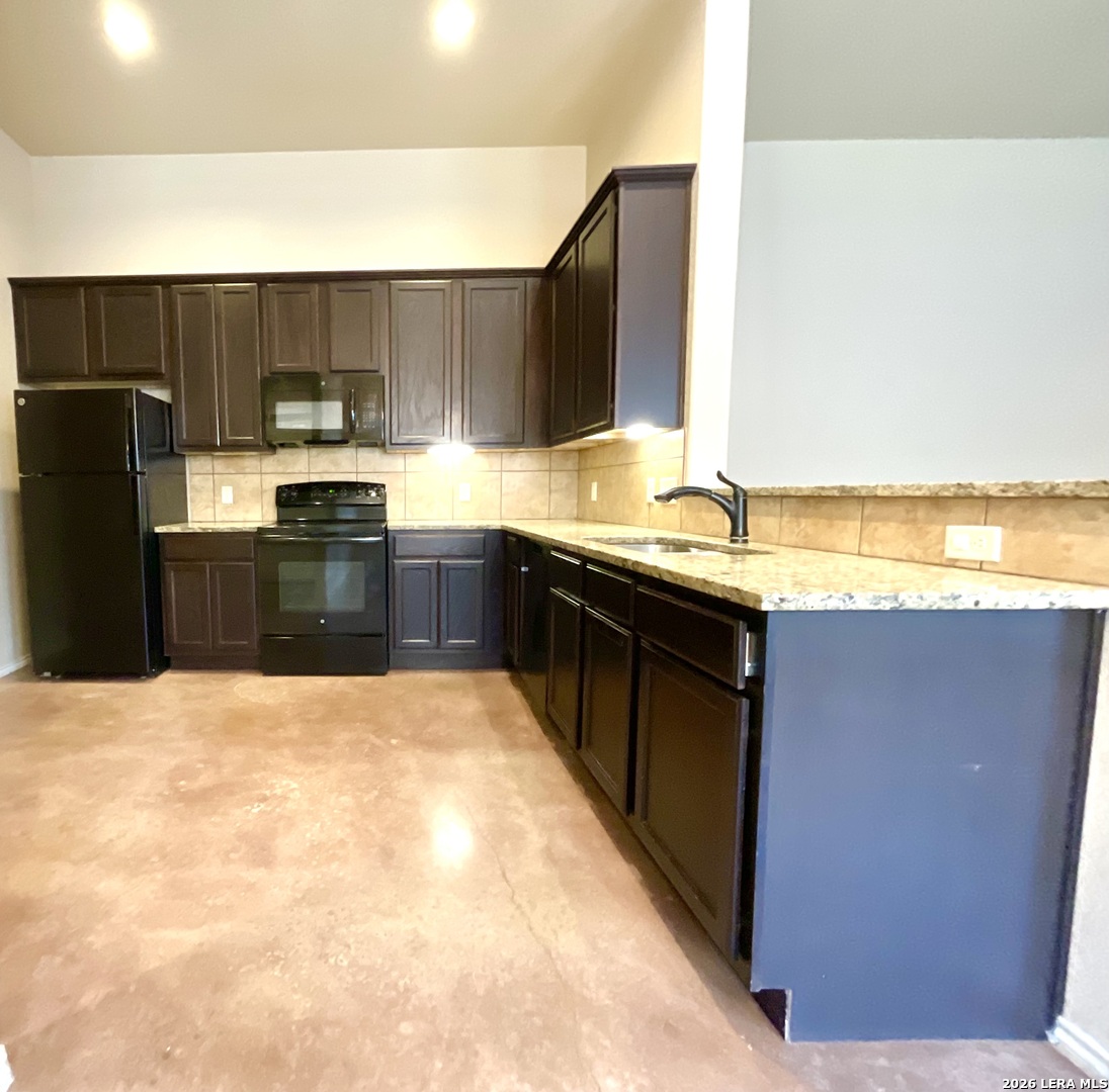 2575 Pahmeyer Road New Braunfels, TX 78130 - Photo 12 of 31 a kitchen with stainless steel appliances granite countertop a sink stove and refrigerator