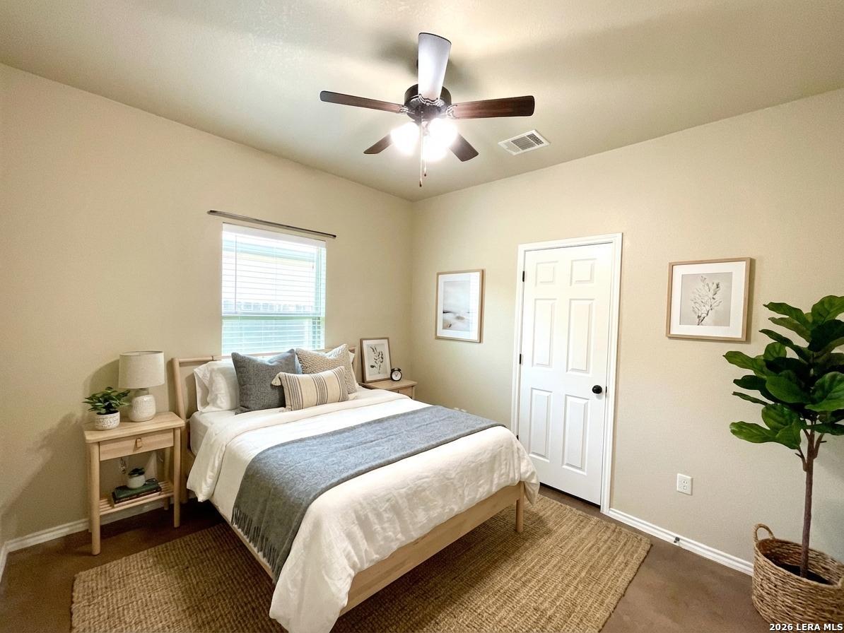 2575 Pahmeyer Road New Braunfels, TX 78130 - Photo 17 of 31 a bedroom with a bed and a potted plant