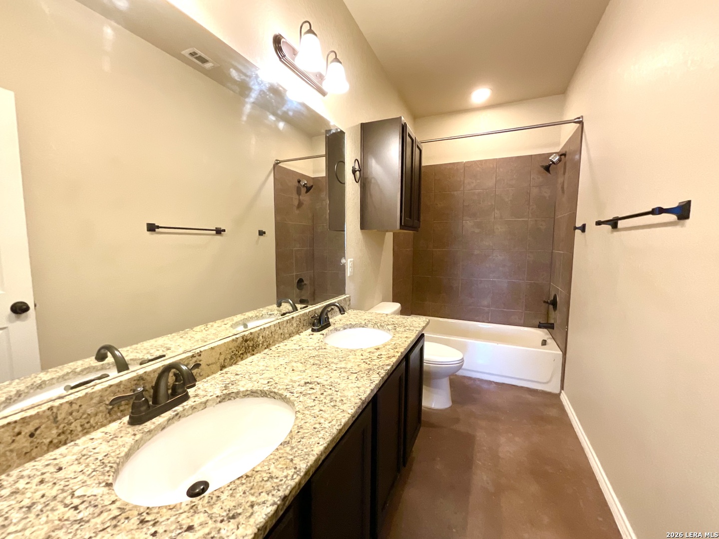 2575 Pahmeyer Road New Braunfels, TX 78130 - Photo 26 of 31 a bathroom with a granite countertop double vanity sink and mirror with bathtub