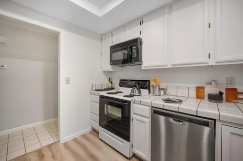 a kitchen with a sink stove and microwave