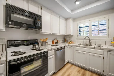 a kitchen with a refrigerator and a sink